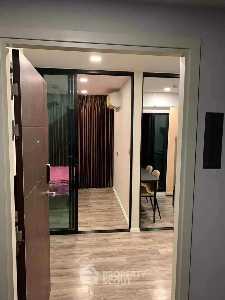 Modern apartment entrance with sleek flooring and stylish dining area