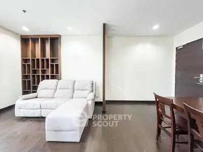 Spacious living room with modern furniture and elegant wooden flooring.