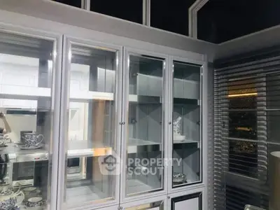 Modern kitchen with glass cabinets and elegant dinnerware display