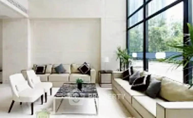 Luxurious modern living room with large windows and elegant furniture