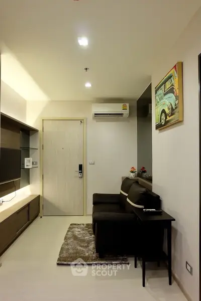 Modern living room with sleek design, featuring a comfortable sofa and stylish decor.