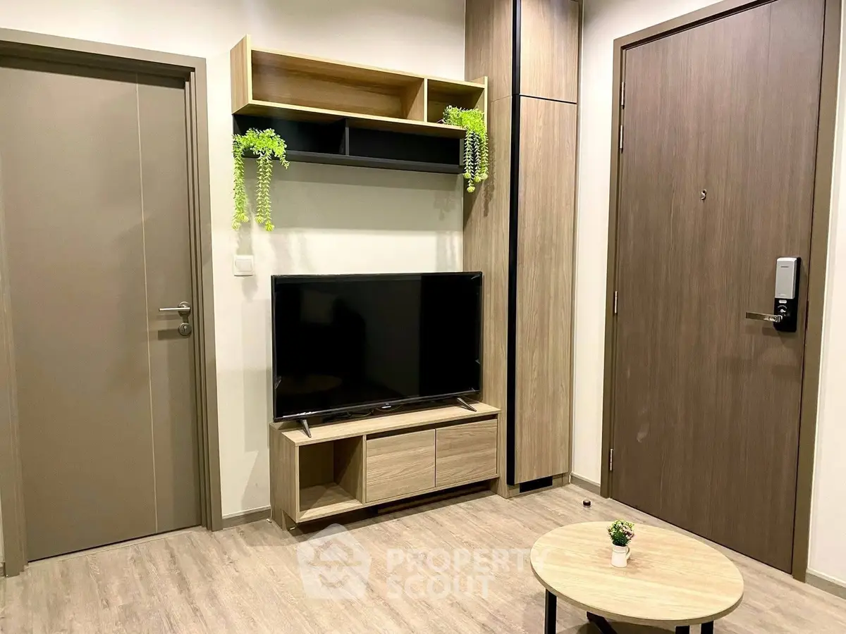 Modern living room with sleek TV stand and stylish decor in contemporary apartment.