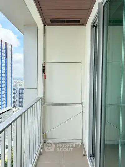 Spacious balcony with city view, perfect for relaxation and enjoying the skyline.
