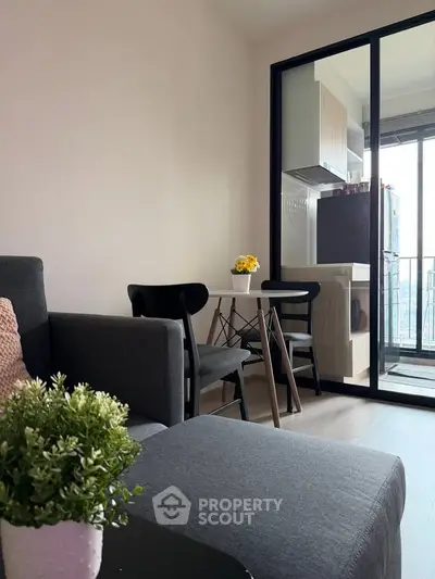 Modern living room with cozy seating and balcony view