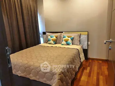 Cozy bedroom with stylish decor and wooden flooring in modern apartment