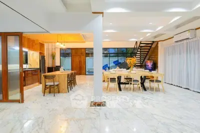 Spacious open-plan living and dining area with modern kitchen and elegant marble flooring.