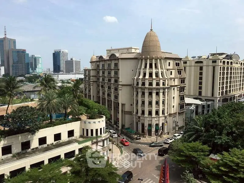 Luxurious cityscape view of elegant high-rise buildings and lush greenery in a vibrant urban setting.