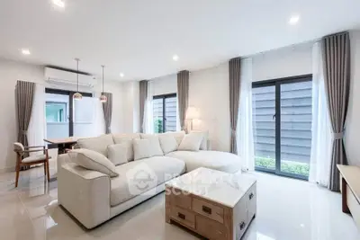 Spacious modern living room with elegant decor and large windows