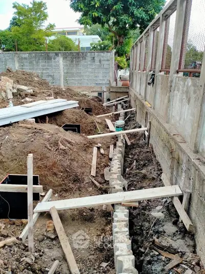 Construction site with foundation work in progress, showcasing early stages of building development.