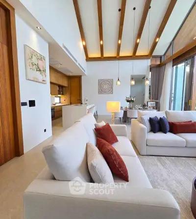 Luxurious open-plan living room with modern decor and elegant lighting