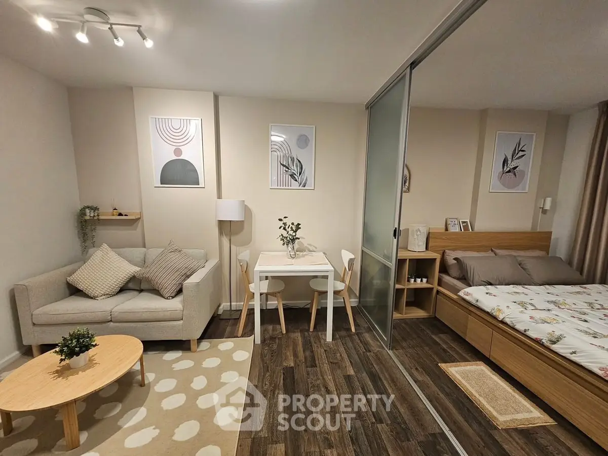 Cozy studio apartment with modern decor and wooden flooring
