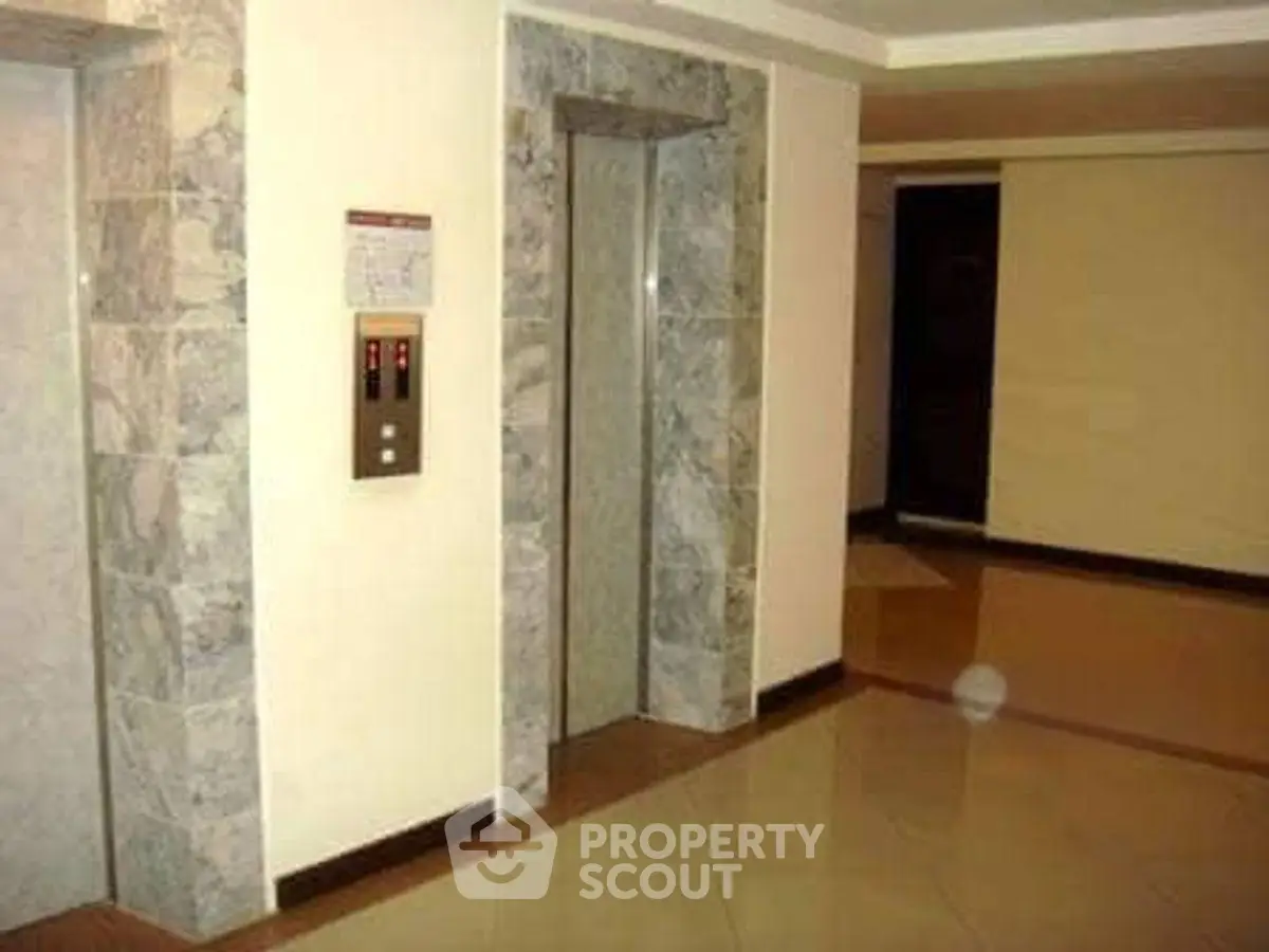 Modern building elevator lobby with sleek design and polished floors.