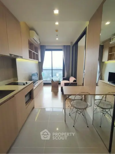 Modern open-layout living room with kitchen and city view