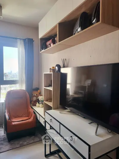 Cozy living room with modern TV setup and city view