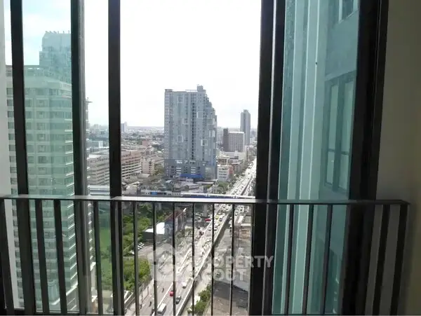 Stunning urban view from high-rise balcony with cityscape and skyline.
