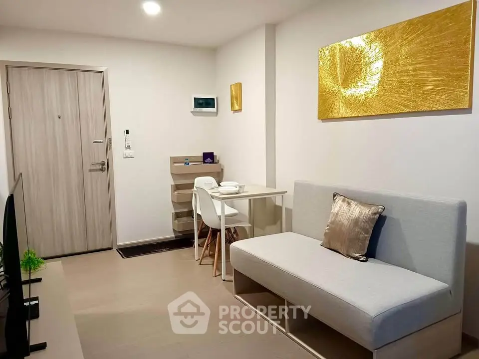 Modern living room with stylish decor and compact dining area in a cozy apartment.