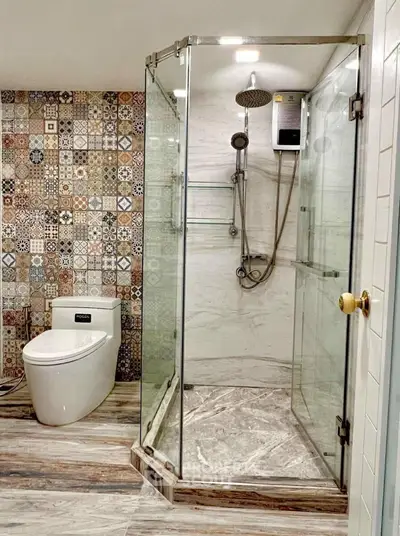Modern bathroom with stylish tile design and glass shower enclosure