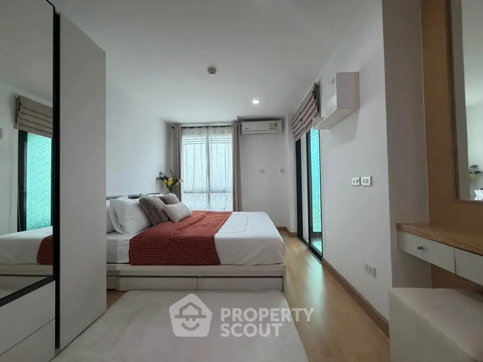 Modern bedroom with stylish decor and natural light in a contemporary apartment.