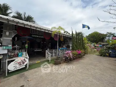 Charming outdoor view of a quaint property with lush garden and inviting entrance.