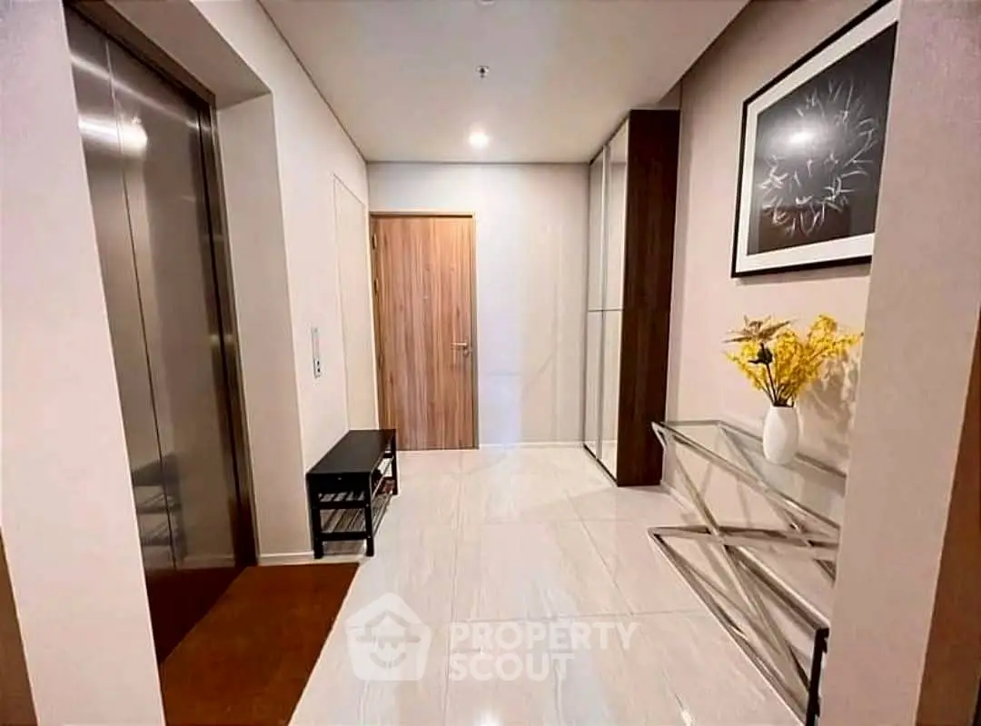 Elegant apartment entrance with elevator and modern decor