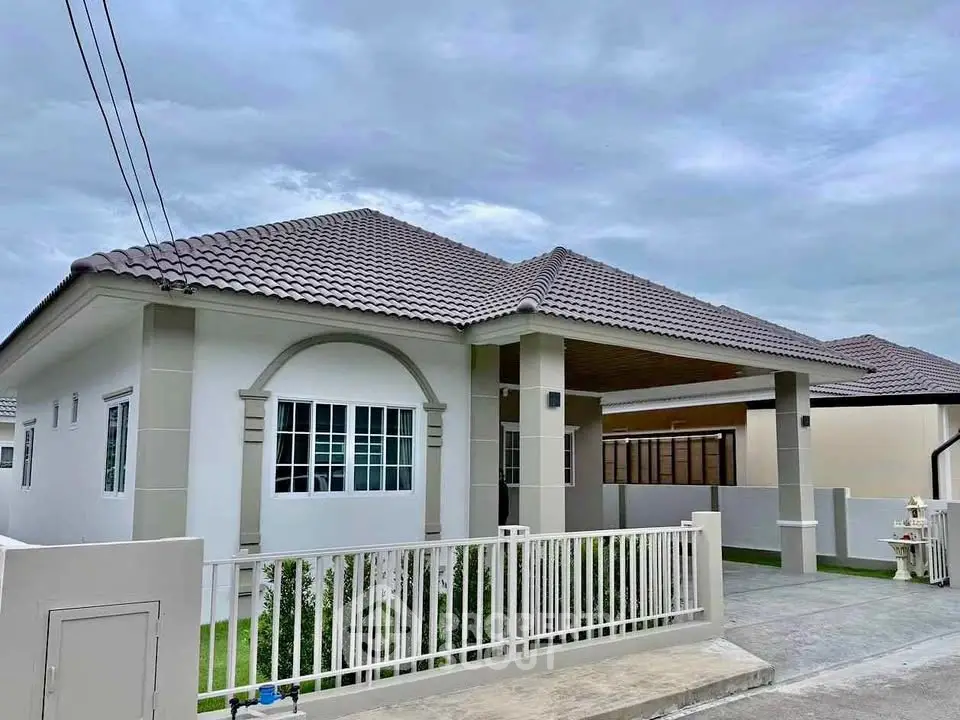 Charming single-story home with modern design and spacious driveway in a serene neighborhood.