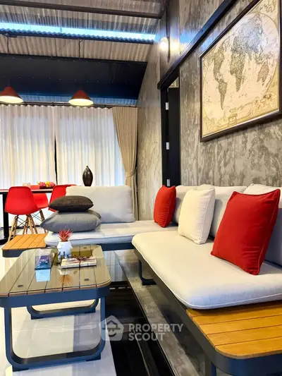 Stylish living room with modern decor, featuring a cozy seating area and elegant map artwork on the wall.