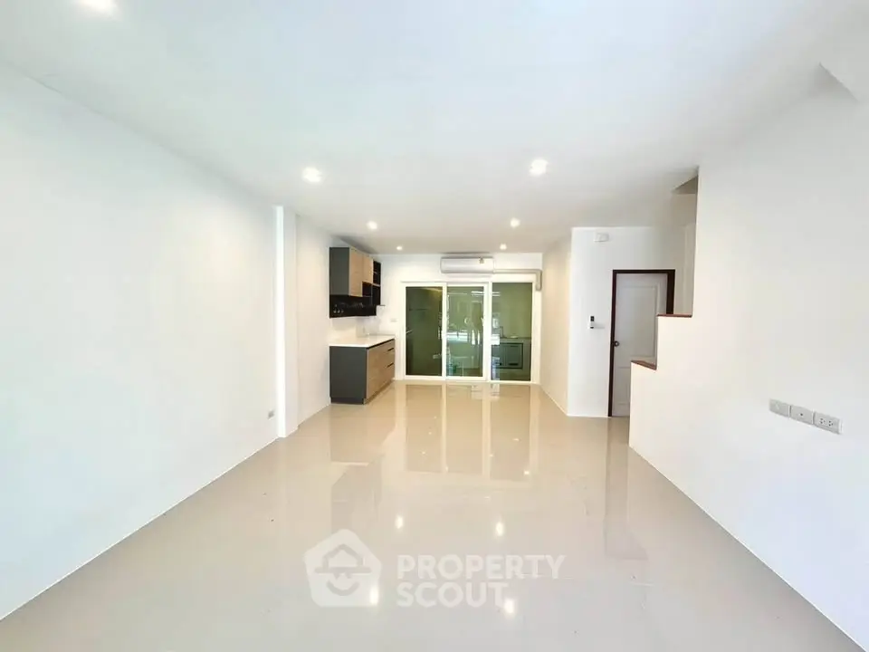 Spacious modern living room with open kitchen layout and sleek finishes