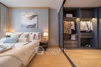 Luxurious bedroom with modern decor and spacious walk-in closet, perfect for stylish living.