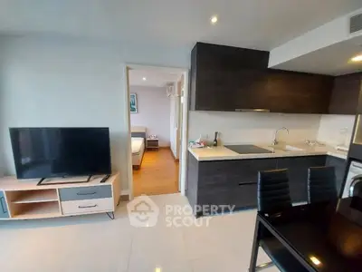 Modern open-plan living room and kitchen with sleek design and natural light.