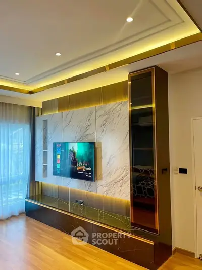 Luxurious living room with modern TV setup and elegant lighting