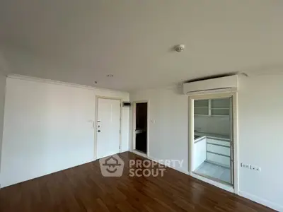 Spacious apartment interior with wooden flooring and modern kitchen