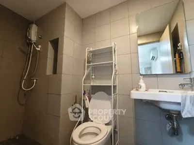 Modern bathroom with shower, toilet, and sleek tile design