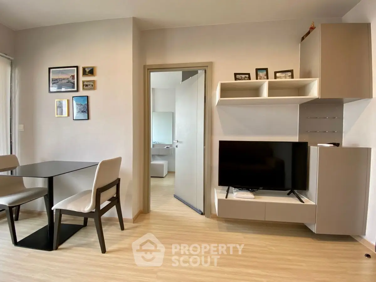 Modern living room with sleek furniture and wall-mounted TV, showcasing contemporary interior design.