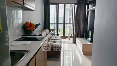 Modern compact living room with sleek kitchen and balcony view