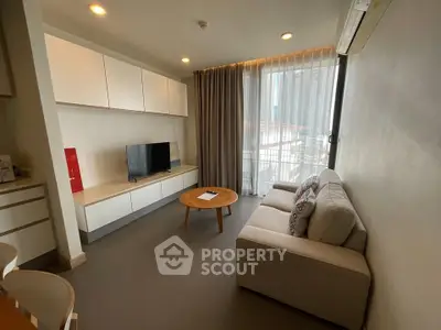 Modern living room with cozy sofa and large window in stylish apartment