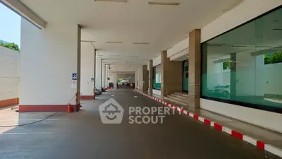 Spacious building entrance with modern design and ample parking space