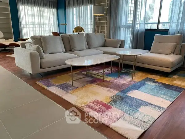 Spacious modern living room with stylish sofa and colorful rug