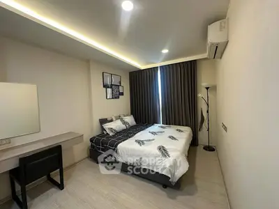 Modern bedroom with stylish decor and natural lighting, featuring a cozy bed and sleek furnishings.