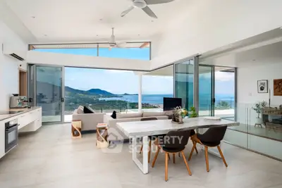 Luxurious open-plan living room with stunning ocean view and modern decor