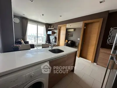 Modern open-layout kitchen with city view and washing machine