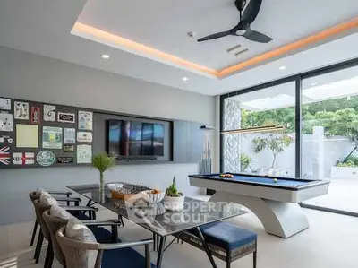 Luxurious modern living room with pool table and garden view