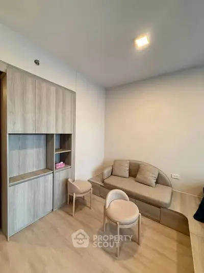 Modern living room with stylish furniture and built-in storage in a cozy apartment.