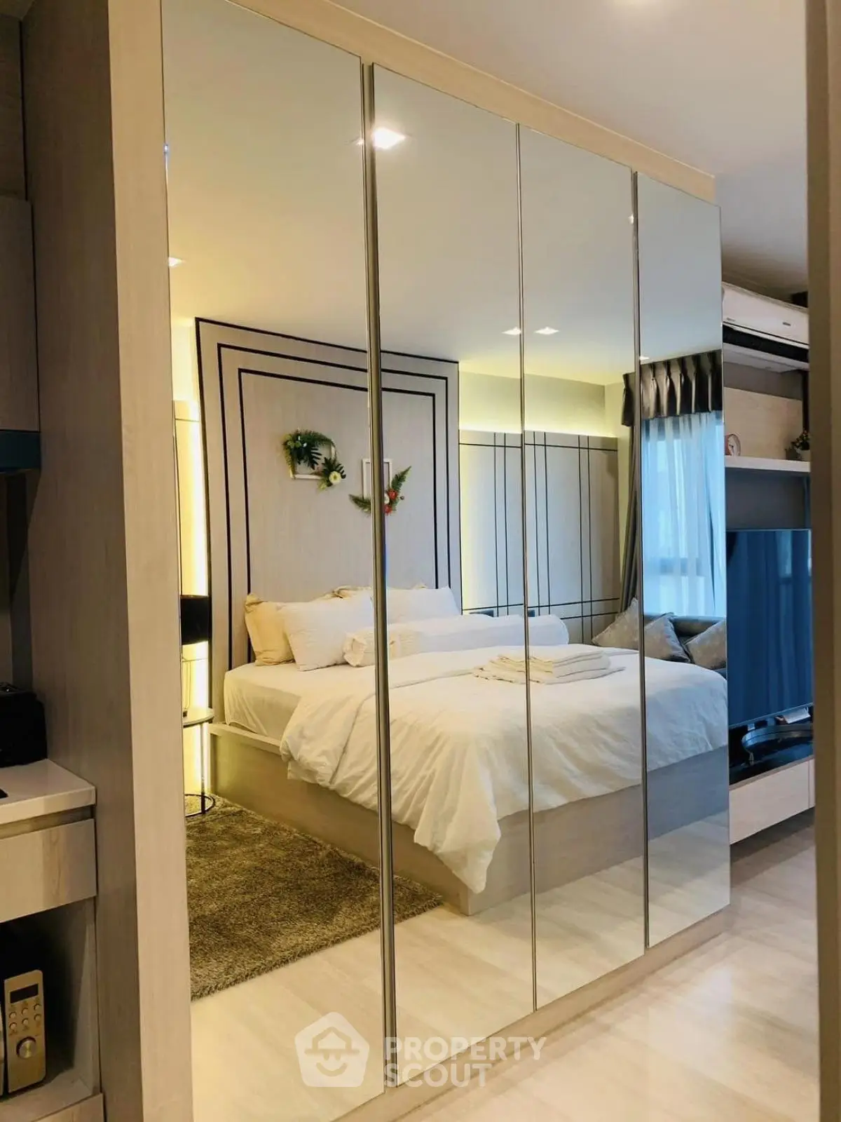 Luxurious bedroom with mirrored wardrobe and cozy lighting