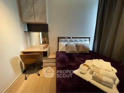 Cozy bedroom with modern decor and workspace, featuring a plush bed and elegant lighting.