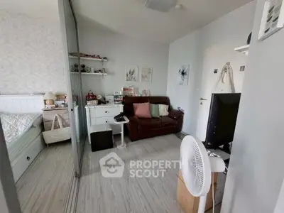 Charming bedroom with cozy seating area and modern decor, perfect for relaxation and comfort.
