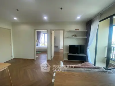 Spacious modern living room with wooden flooring and natural light