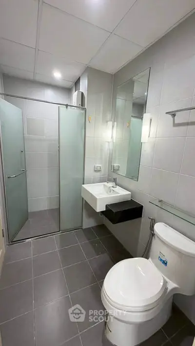 Modern bathroom with sleek fixtures and glass shower enclosure