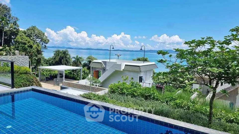 Stunning ocean view from luxury poolside villa with lush greenery