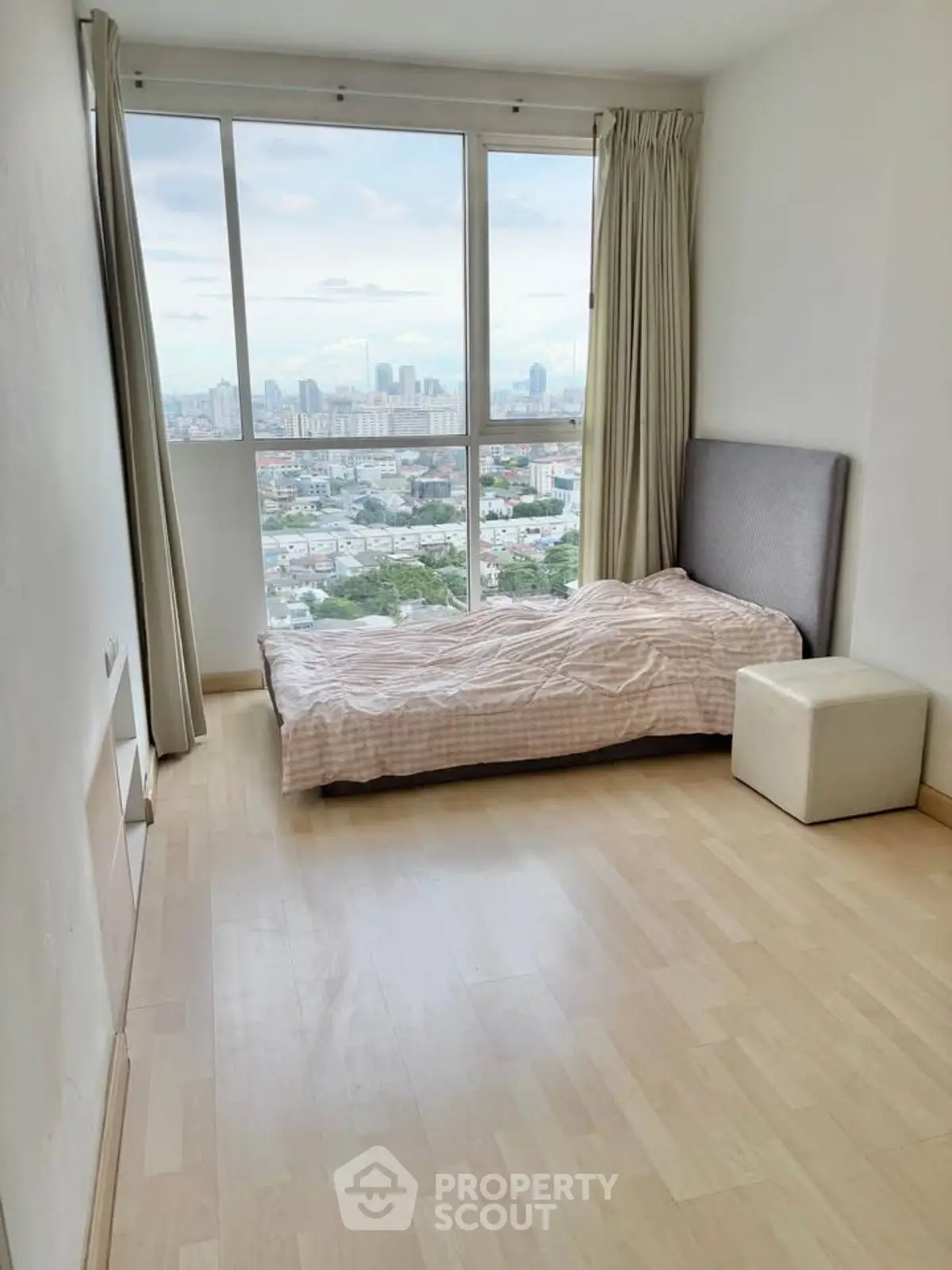 Spacious bedroom with stunning city view and natural light