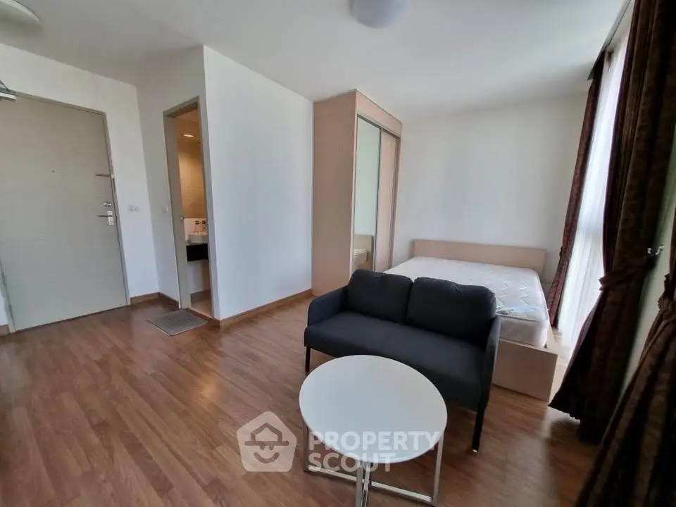 Modern studio apartment with cozy living area and natural light